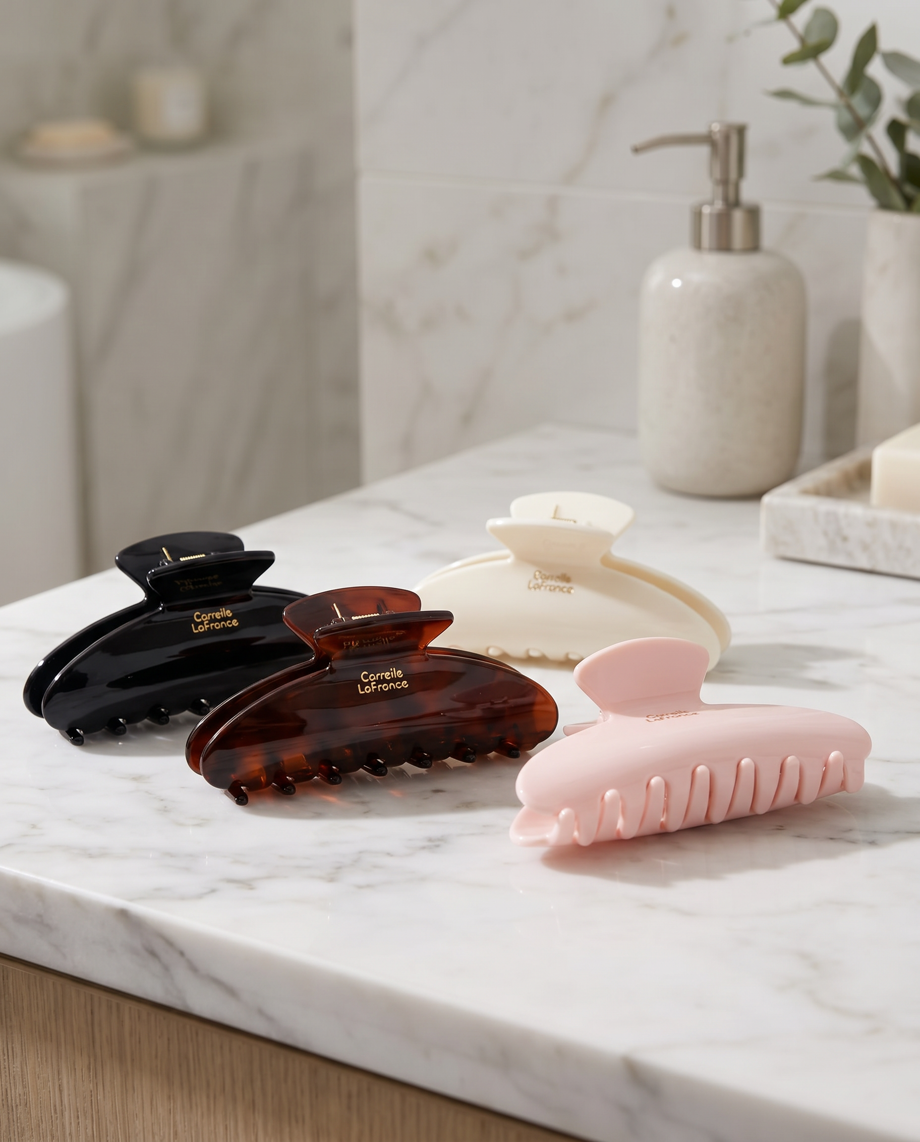 Large hair claw clips on marble surface